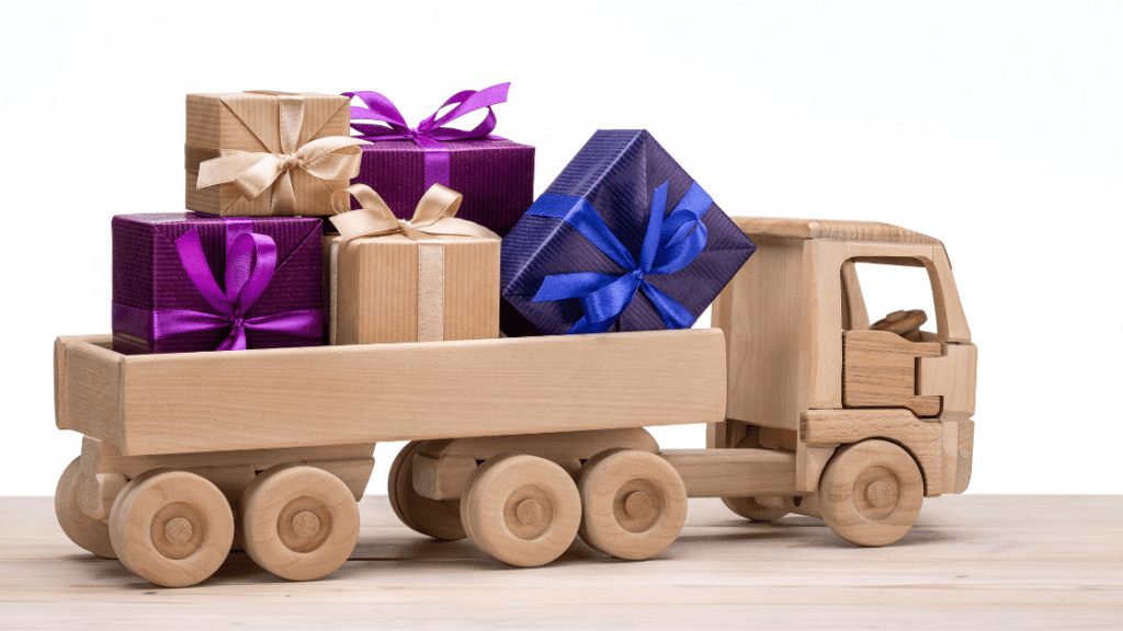 wooden toy truck with colorful gifts at the back